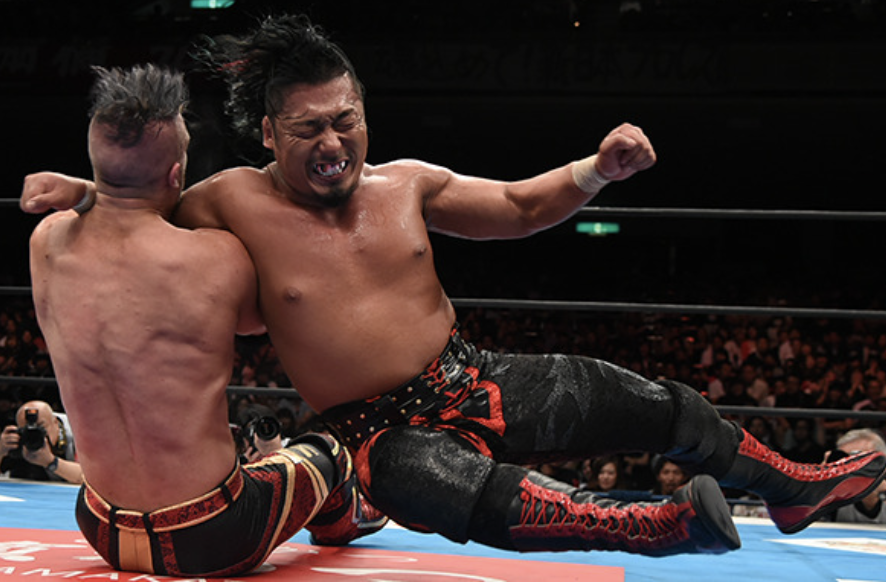 Shingo Takagi executes a sliding lariat on a seated Will Ospreay.