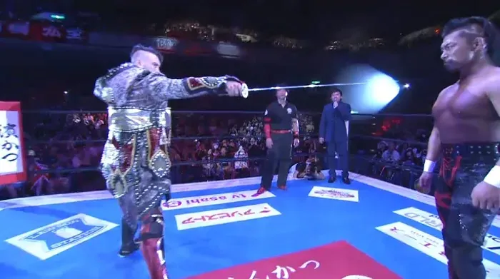 Will Ospreay points a samurai sword at Shingo Takagi before their match.